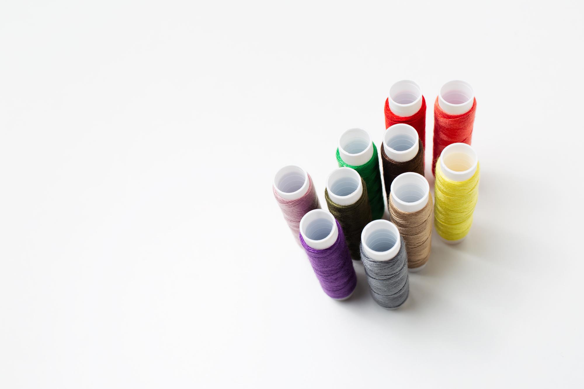 Close-up colored thread palette and bobbins