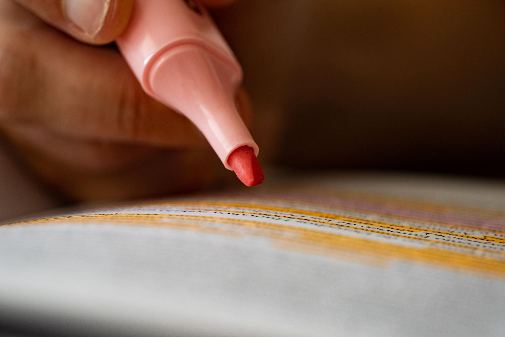 Hand finishing edge of embroidered emblem