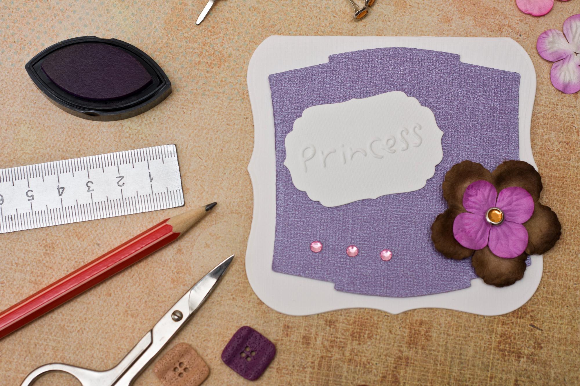 Flatlay of embroidered samples and pricing notes